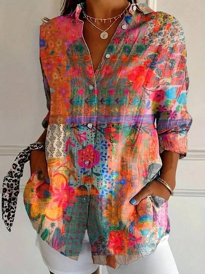 Modern women's relaxed fit blouse with vibrant abstract print. Effortless style for day-to-night.