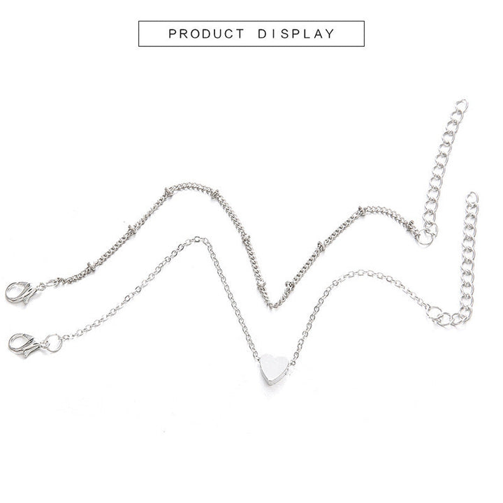 Elegant women's adjustable heart bracelet in gold with white charms, a perfect jewelry accessory.