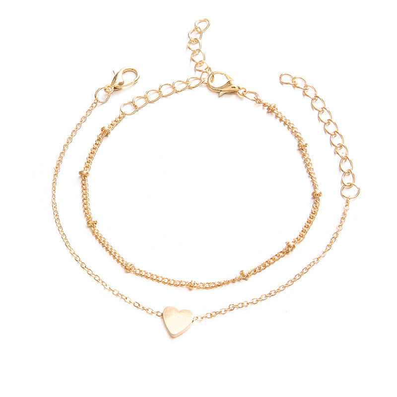 Stylish women's gold adjustable bracelet with charming white heart designs, ideal for gifting.