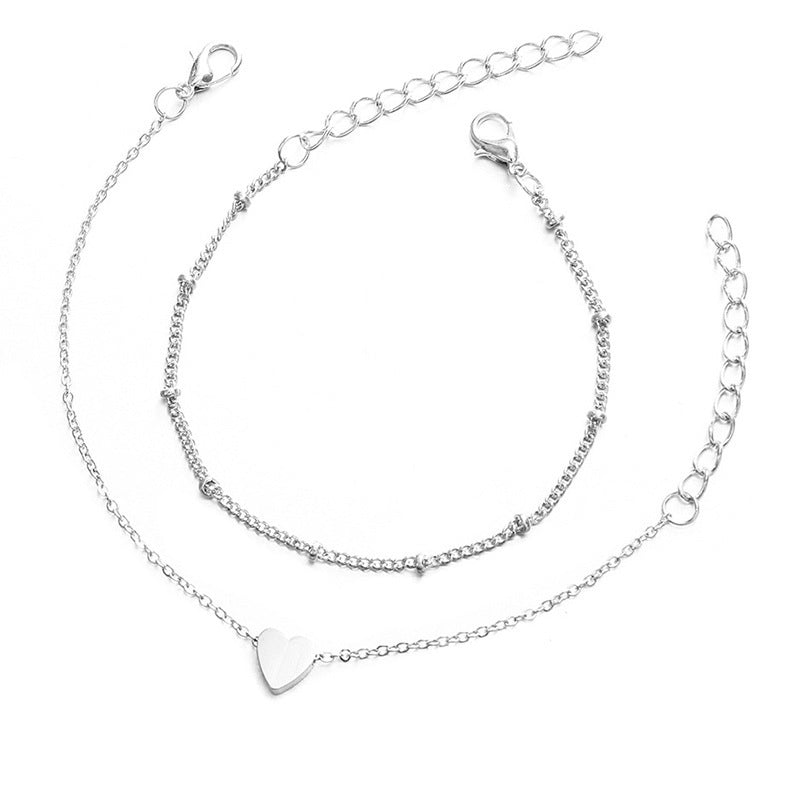 Adjustable women's bracelet with sparkling white heart charms on a gold chain, beautiful jewelry.