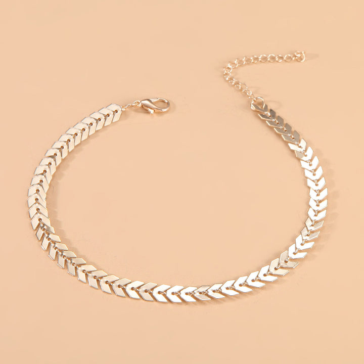 Shiny gold women's adjustable herringbone chain anklet, a delicate and elegant summer foot jewelry piece.