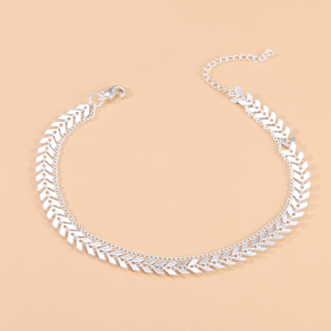 Elegant women's herringbone chain anklet, adjustable gold-tone for stylish summer wear and foot fashion.