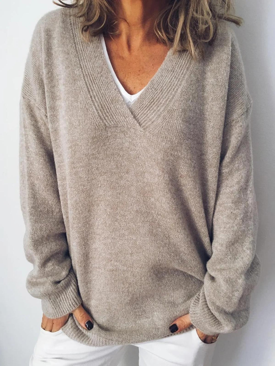 Women's apricot V-neck long-sleeve sweater. Cozy, casual knit pullover for everyday wear.