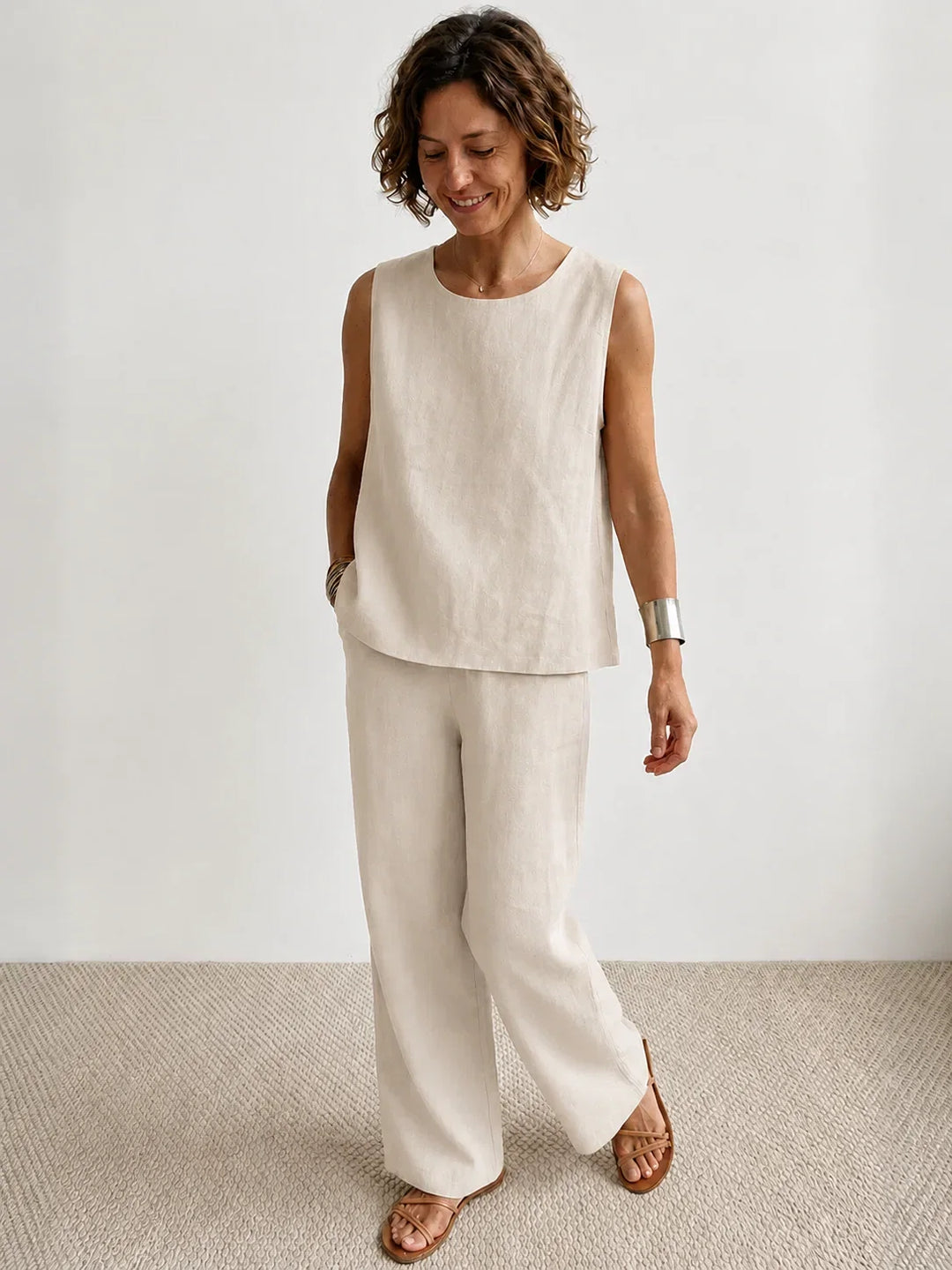 Beige women's spring fashion: sleeveless top & wide-leg pants matching set. Comfortable outfit.
