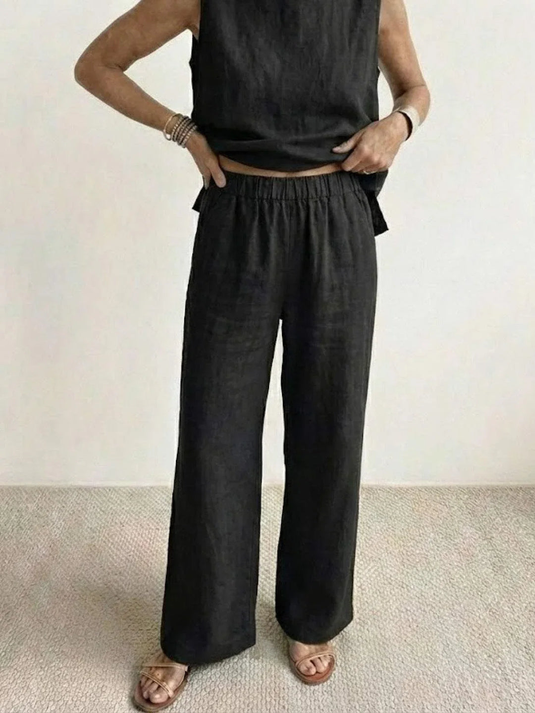 Beige women's casual set: sleeveless cropped top & high-waisted wide-leg pants outfit.