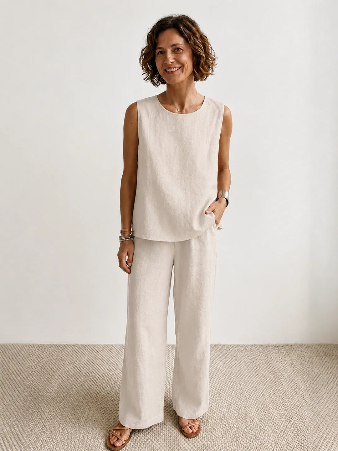 Stylish women's beige sleeveless top and wide-leg pants set. Perfect for spring fashion.