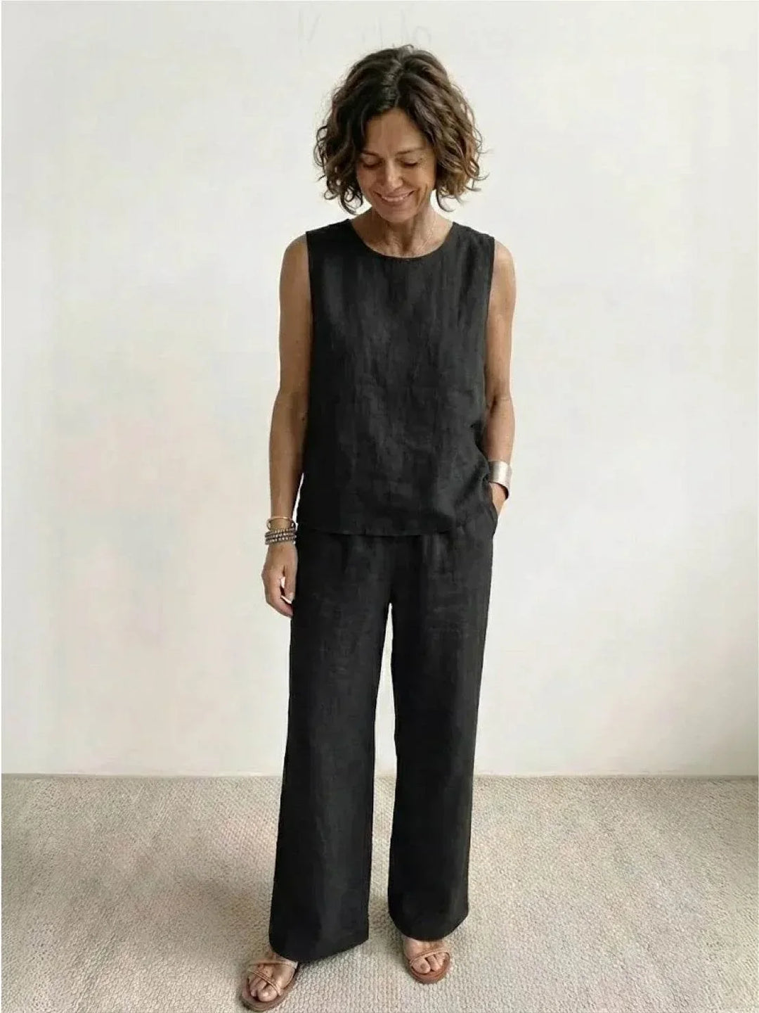 Black two-piece outfit for women: comfy sleeveless top & wide-leg trousers. Casual wear.