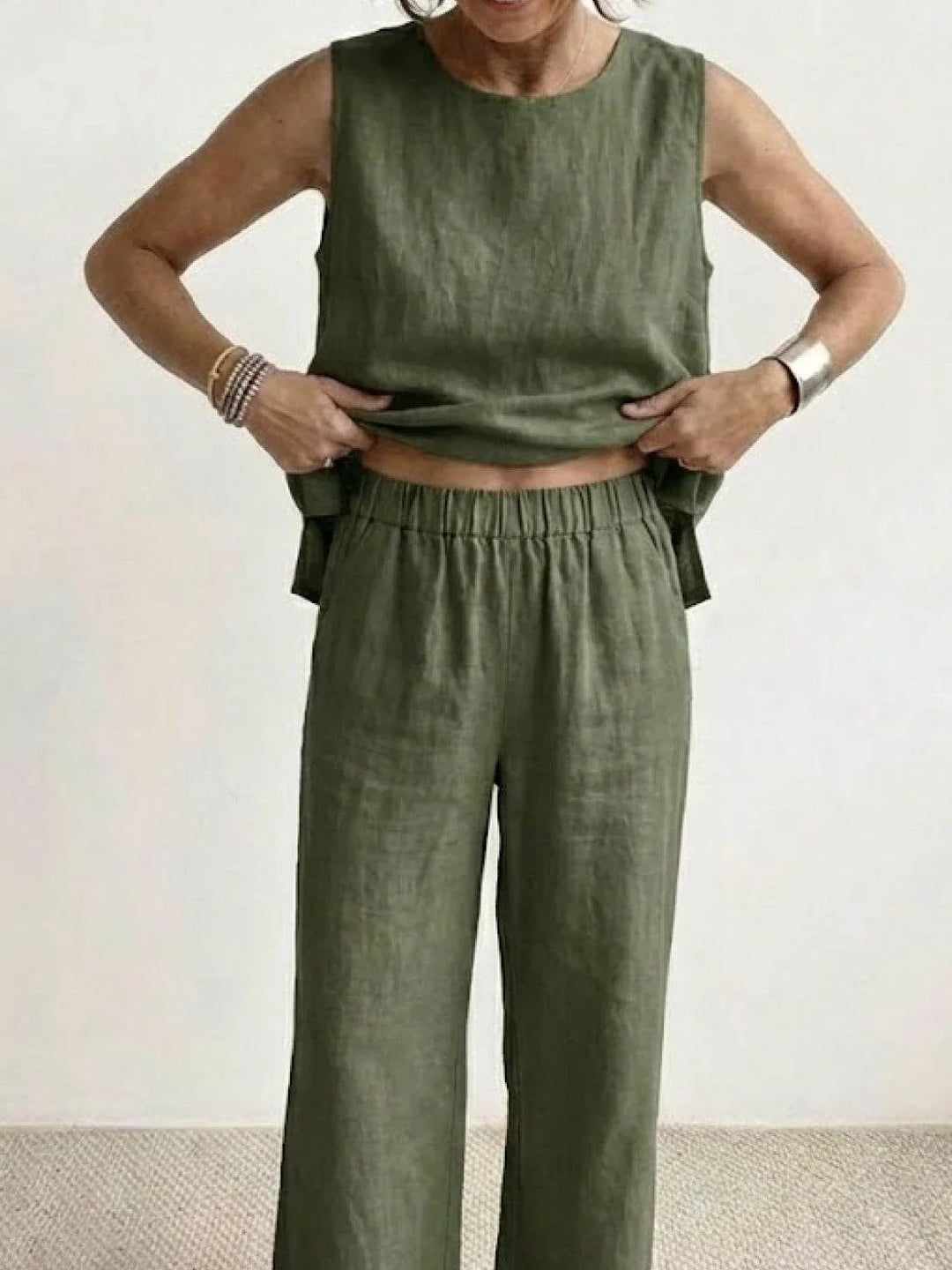 Black sleeveless top & wide-leg pants set for women. Chic and comfortable spring attire.
