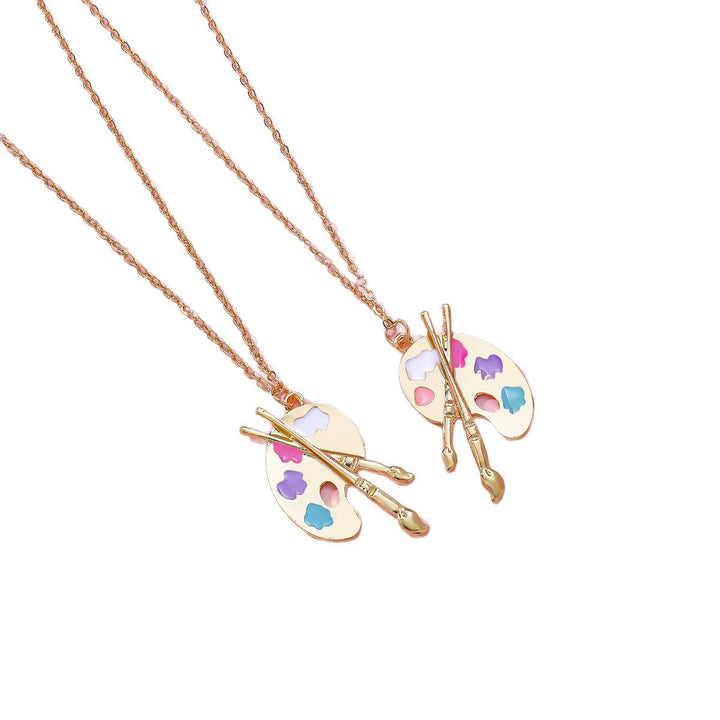 Gold-tone artist palette necklace with colorful enamel dots and a small brush charm, unique women's jewelry.