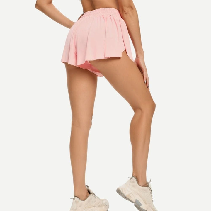 Black women's tennis skirt with built-in shorts. Perfect activewear with adjustable drawstring.