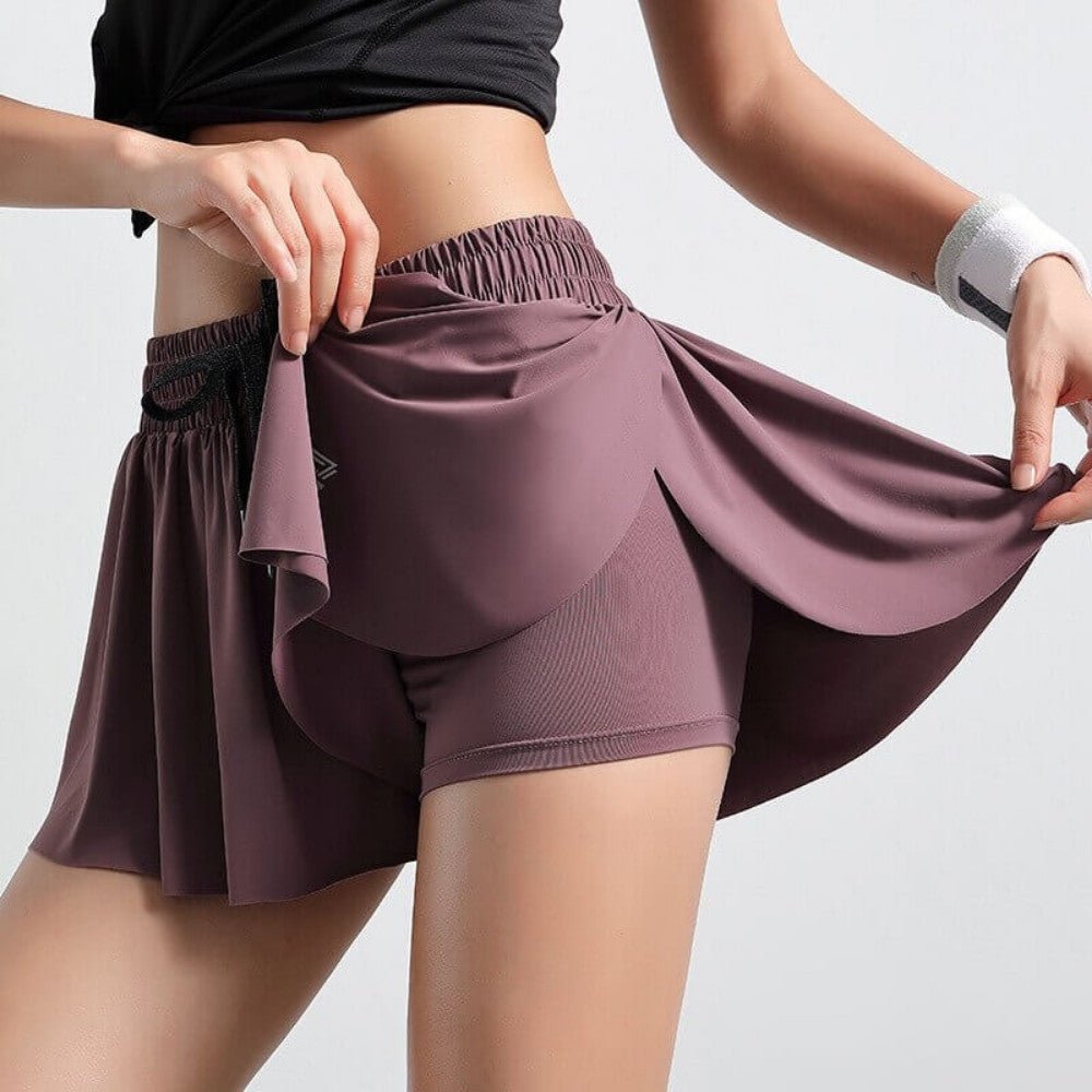 Navy women's golf skort, built-in shorts, and drawstring waist. Comfortable sports apparel.