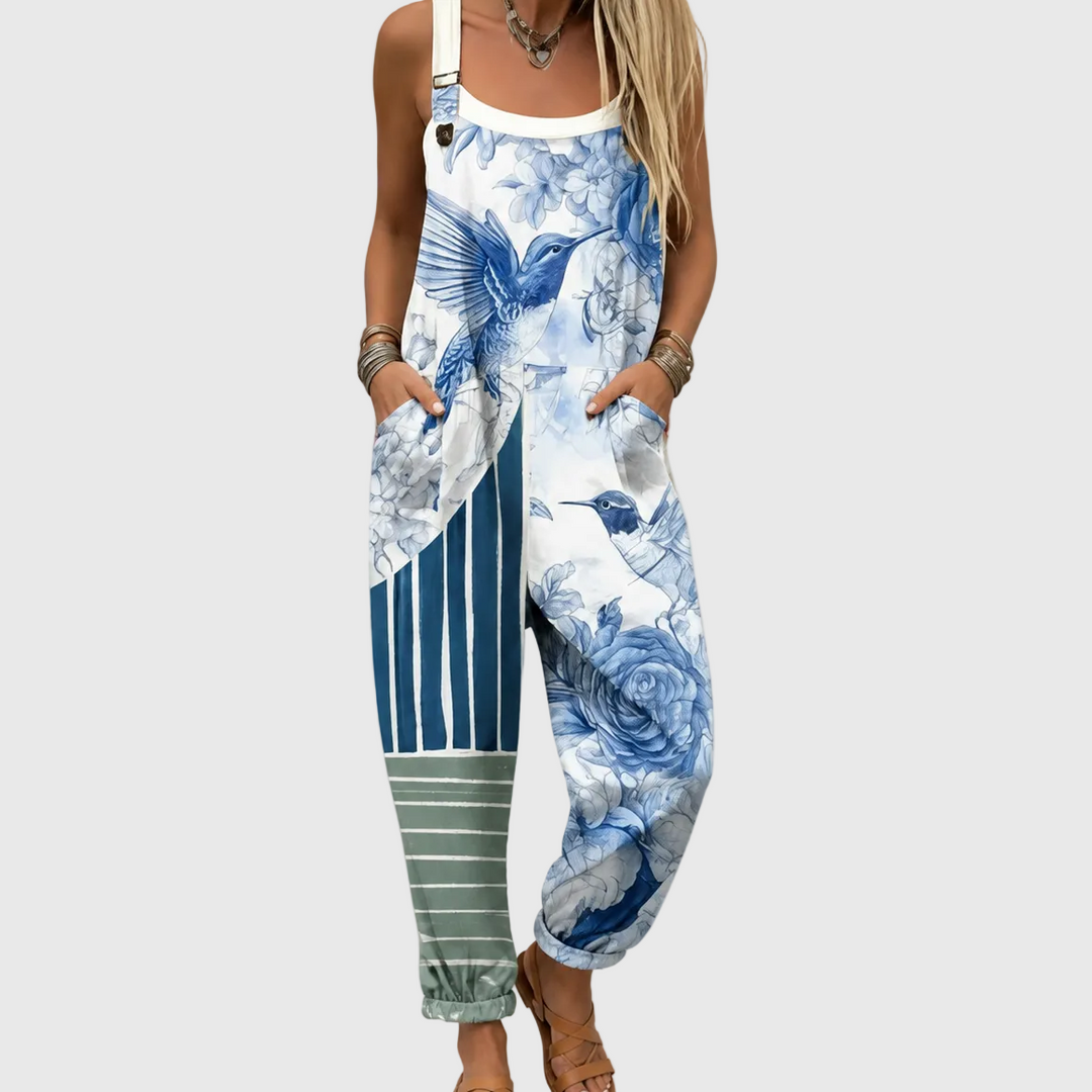 Women's Azure Garden Floral Overalls. Relaxed fit blue floral jumpsuit with adjustable straps & pockets, perfect for summer.