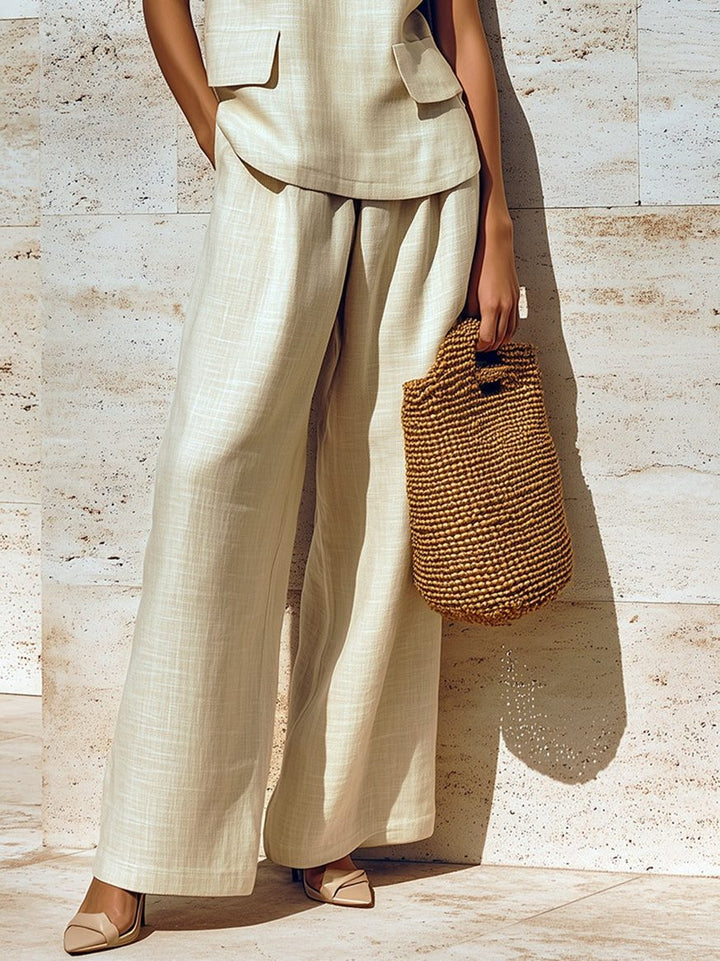 Comfortable women's beige linen sleeveless wide-leg two-piece set. Relaxed summer fashion for women.