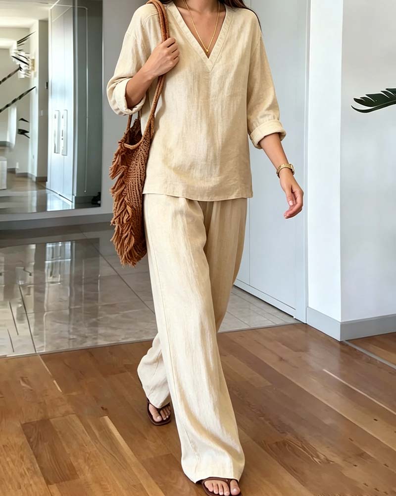 Chic women's beige co-ord set featuring a V-neck long-sleeve top & wide-leg pants. Stylish & comfy.