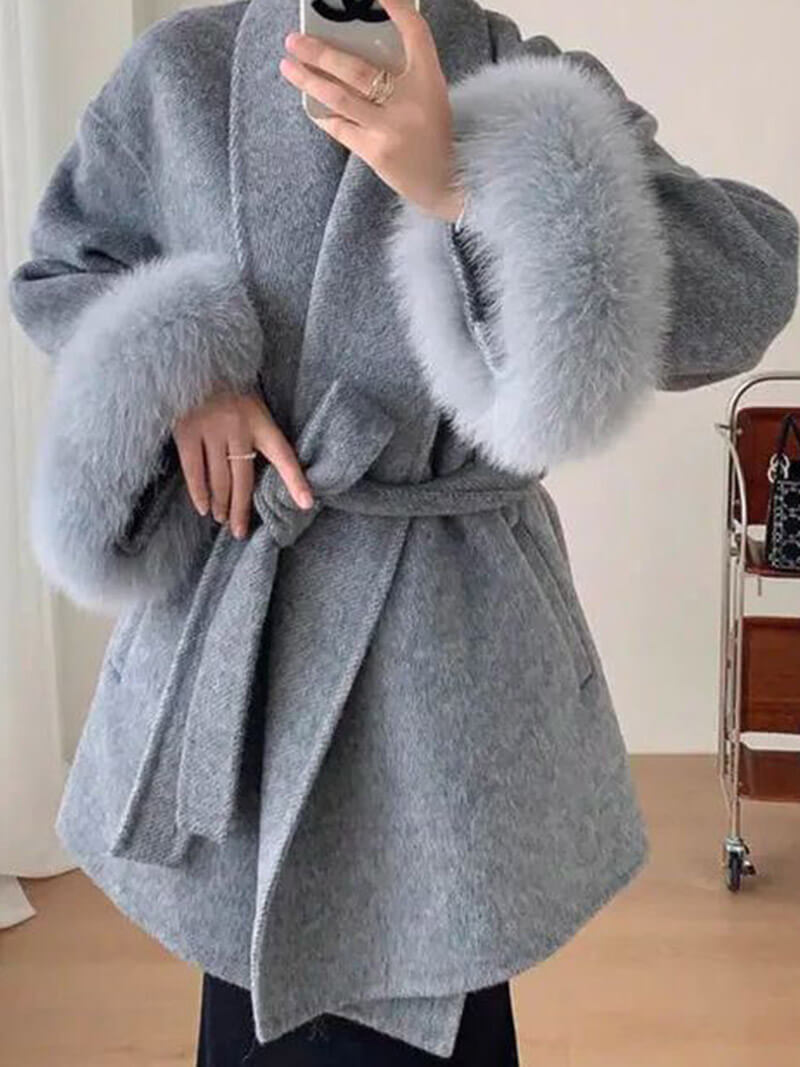Chic women's belted wrap coat, elegant outerwear with luxurious faux fur trimmed sleeves.