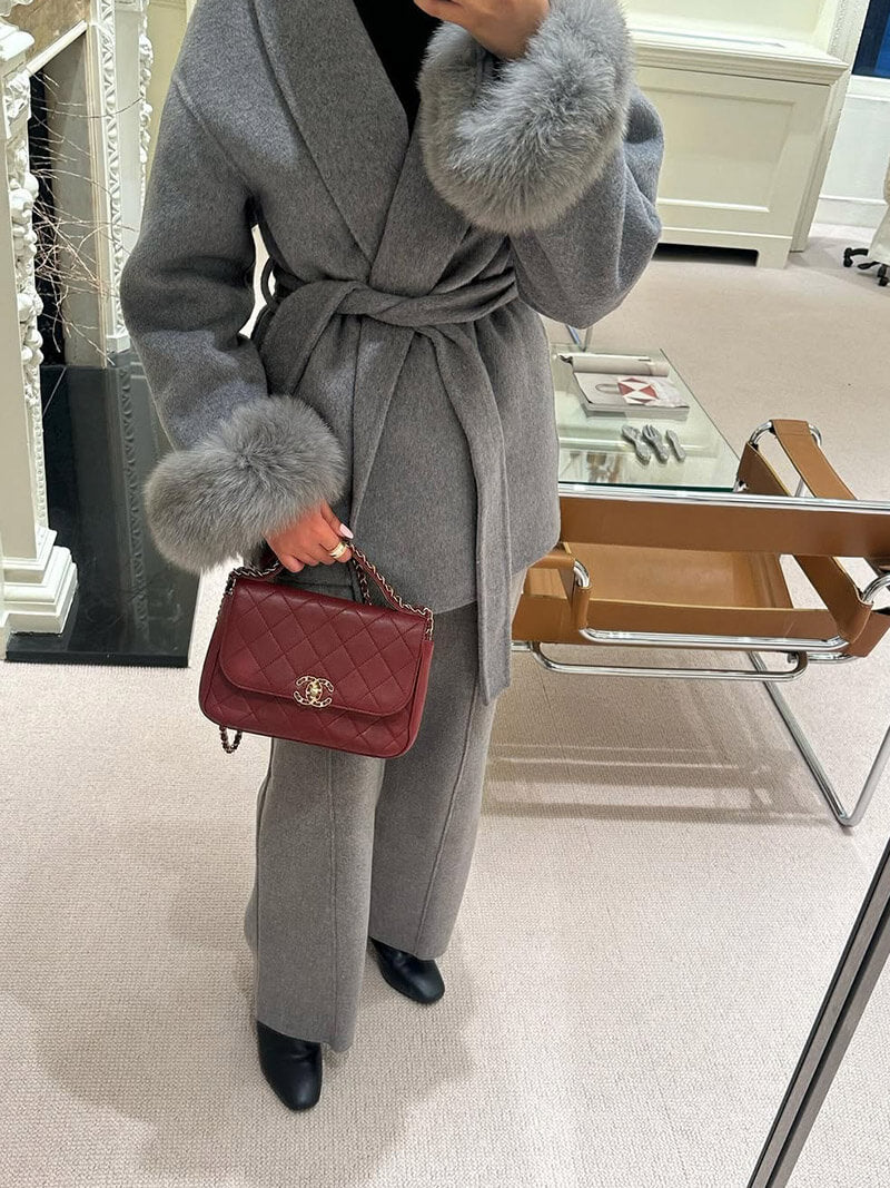 Sophisticated women's winter coat, with a classic wrap style & opulent faux fur cuffs.