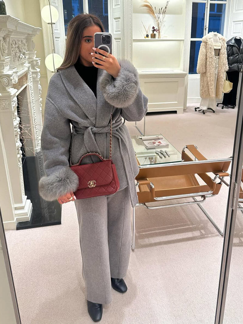 Fashion-forward women's jacket: a belted wrap coat with exquisite faux fur cuffs.