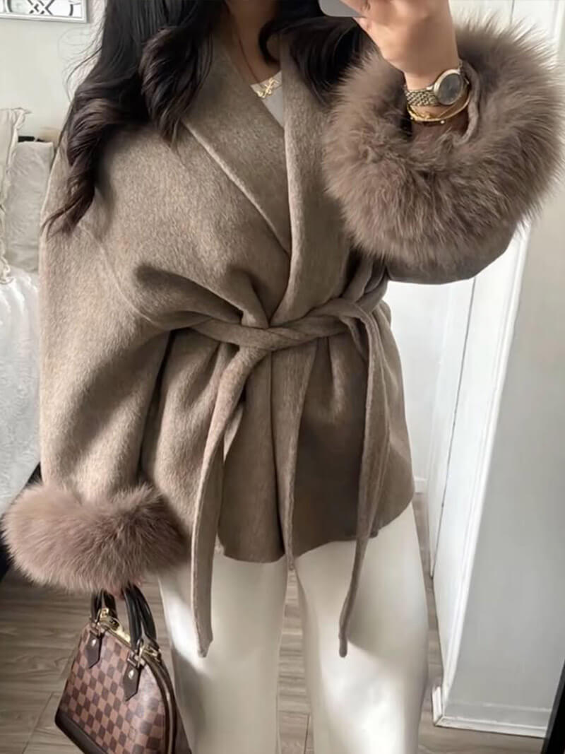 Luxurious women's outerwear: belted wrap coat with rich faux fur cuffs, perfect for cold days.
