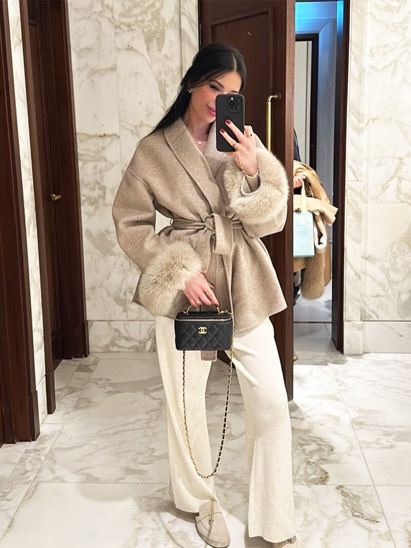 Elegant women's jacket, a timeless belted wrap coat featuring plush faux fur cuffs.