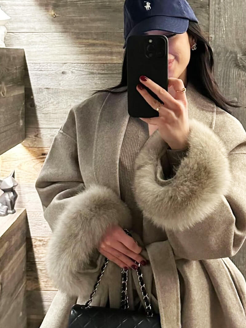 Stylish women's winter coat, featuring a flattering wrap design & luxurious faux fur cuffs.