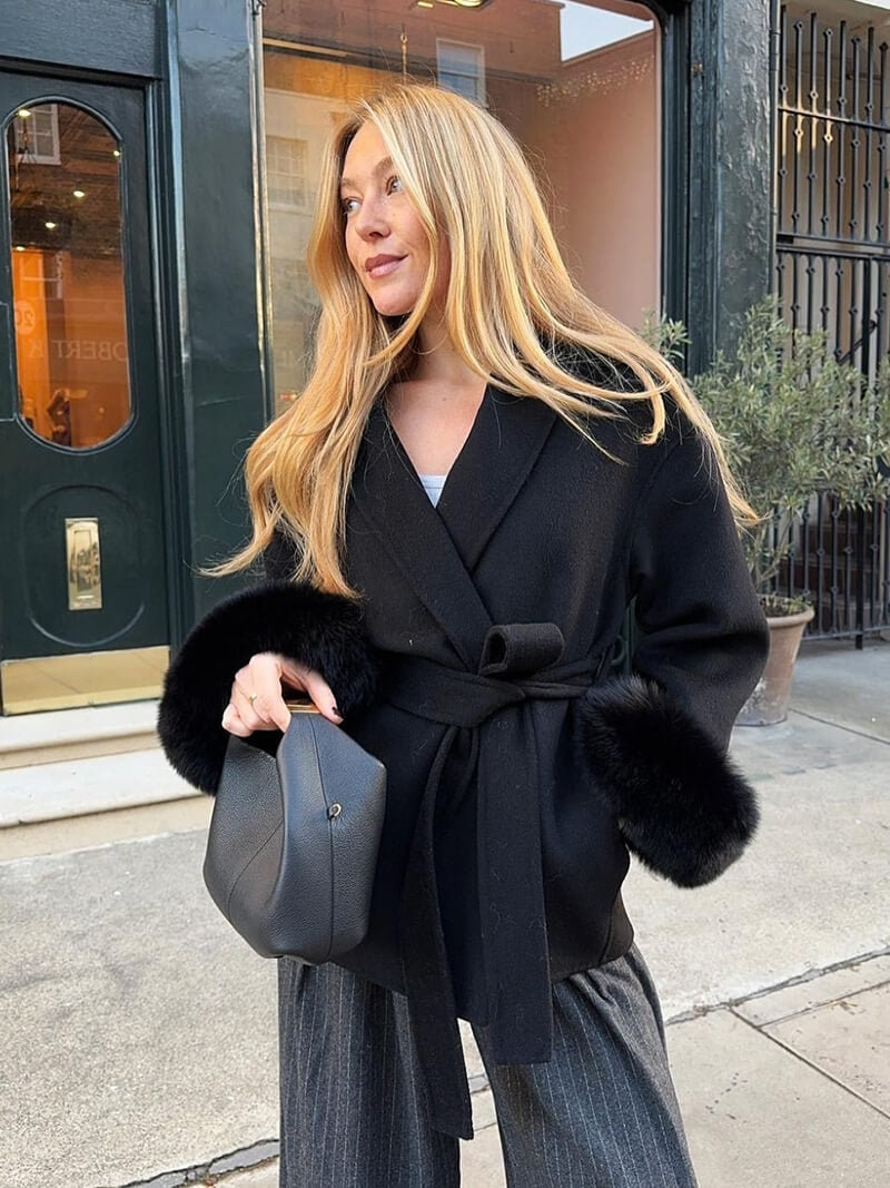 Women's cold weather jacket: a chic belted wrap coat with elegant faux fur cuffs.