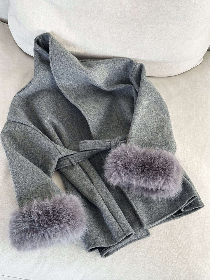 Stylish women's jacket: a wrap coat with a flattering belt and exquisite faux fur cuffs.