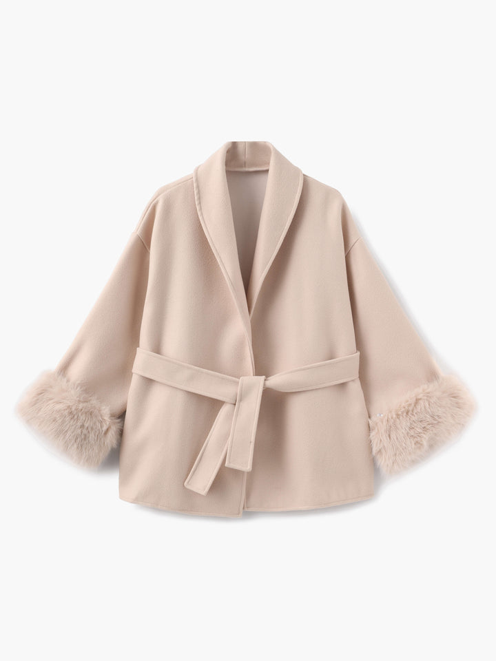 Elegant women's belted winter coat, perfect for cold weather, adorned with luxurious faux fur cuffs.