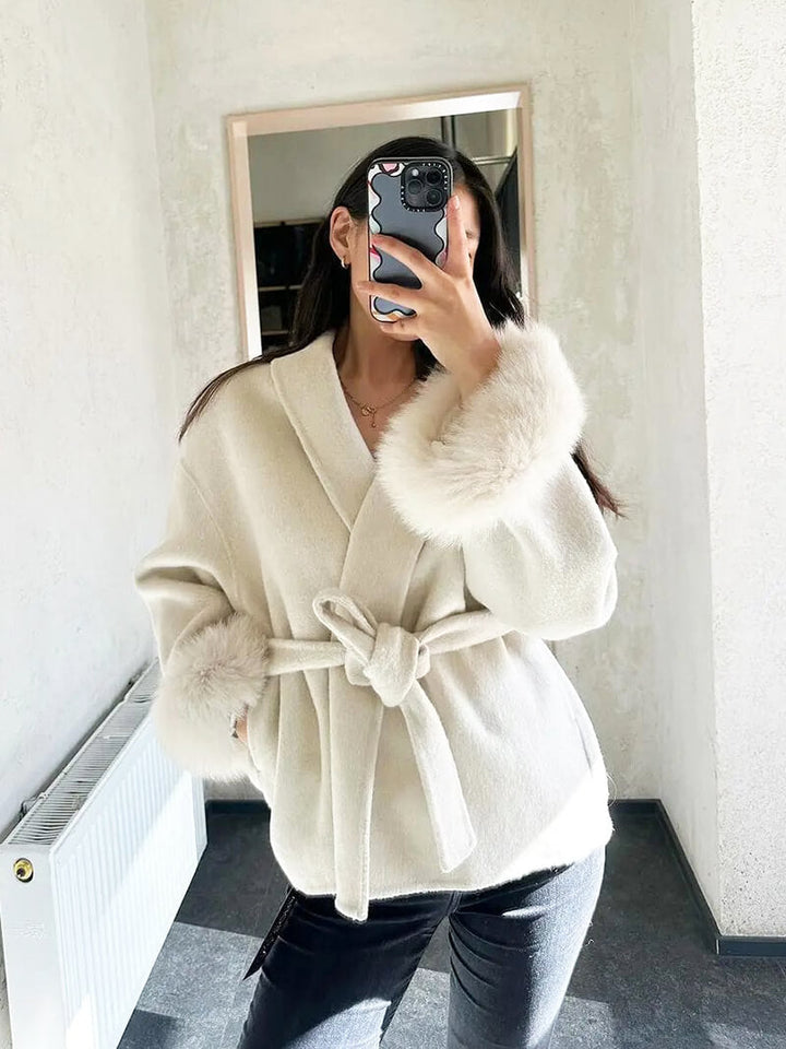 Women's luxury belted coat with elegant faux fur cuffs, a stylish choice for winter.