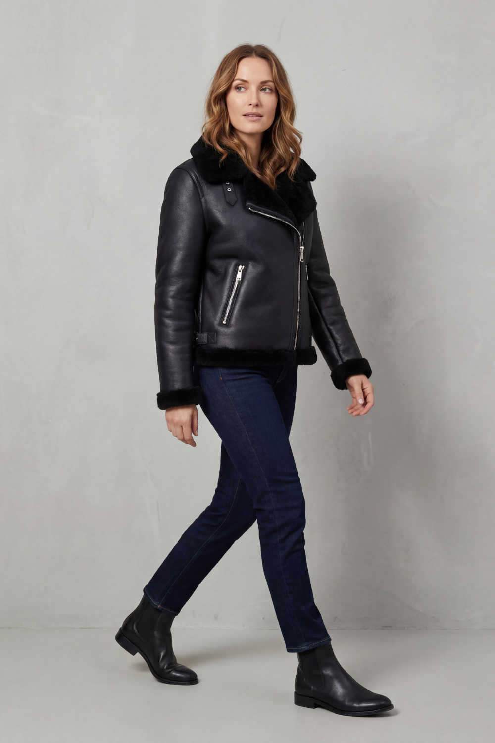 Cozy black asymmetrical women's jacket. Features a stylish zip and biker design, ideal for winter fashion.