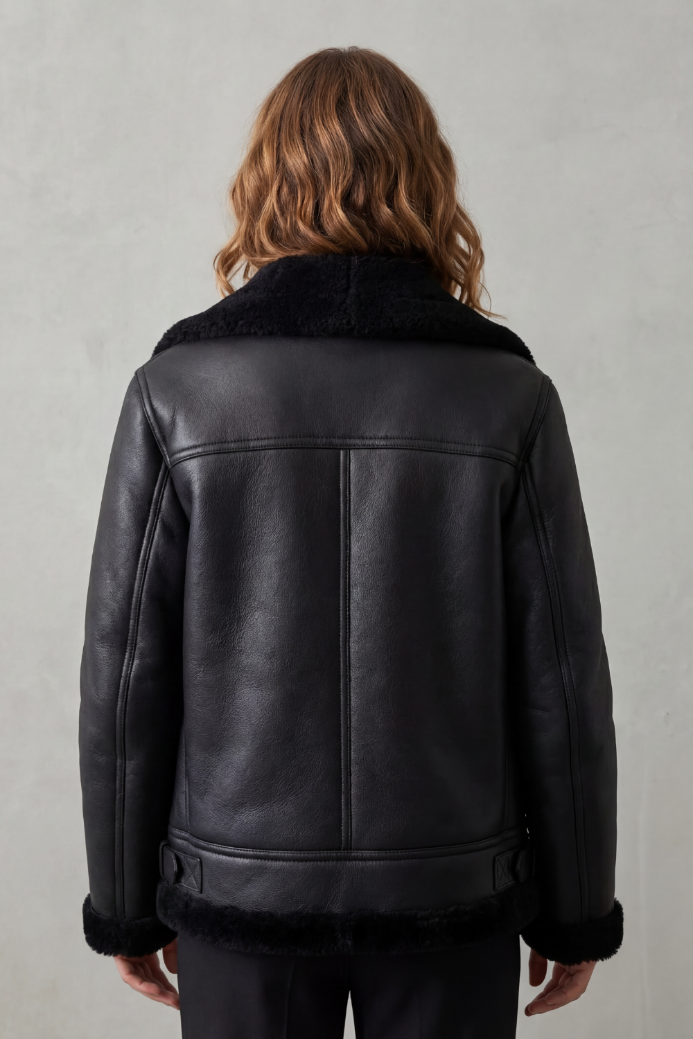 Chic women's outerwear: an asymmetrical zip biker jacket in black, offering a trendy and comfortable fit.