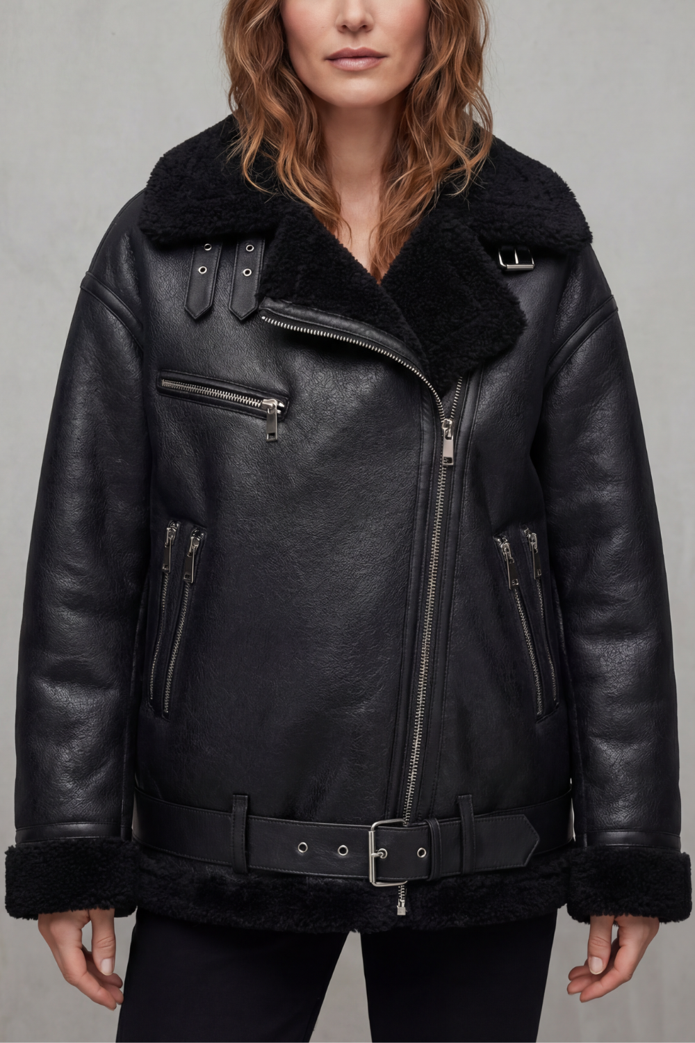 Fashionable women's belted aviator jacket, a versatile black winter coat combining warmth and iconic style.