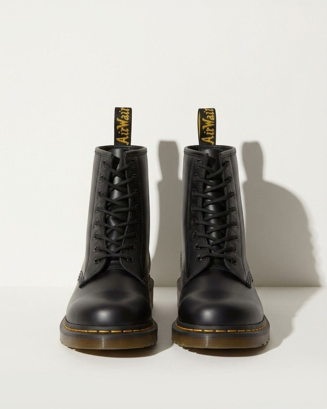 Women's black combat ankle boots with lace-up detail, perfect for motorcycle style and edgy urban fashion.
