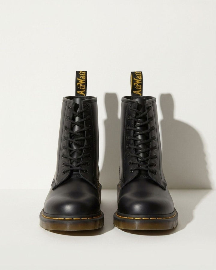Women's black combat ankle boots with lace-up detail, perfect for motorcycle style and edgy urban fashion.