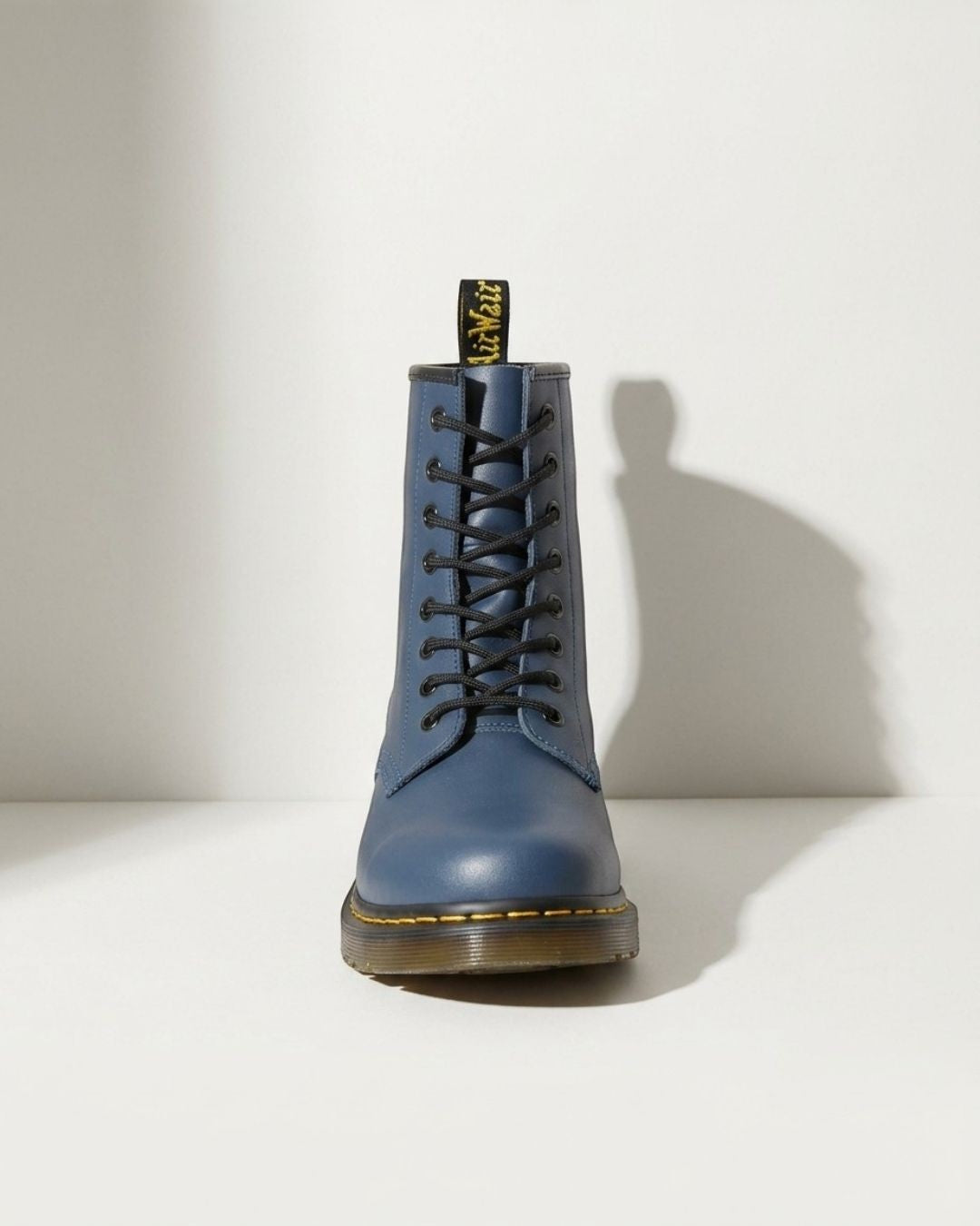 Women's black combat ankle boots, featuring a classic lace-up design and robust motorcycle boot style.