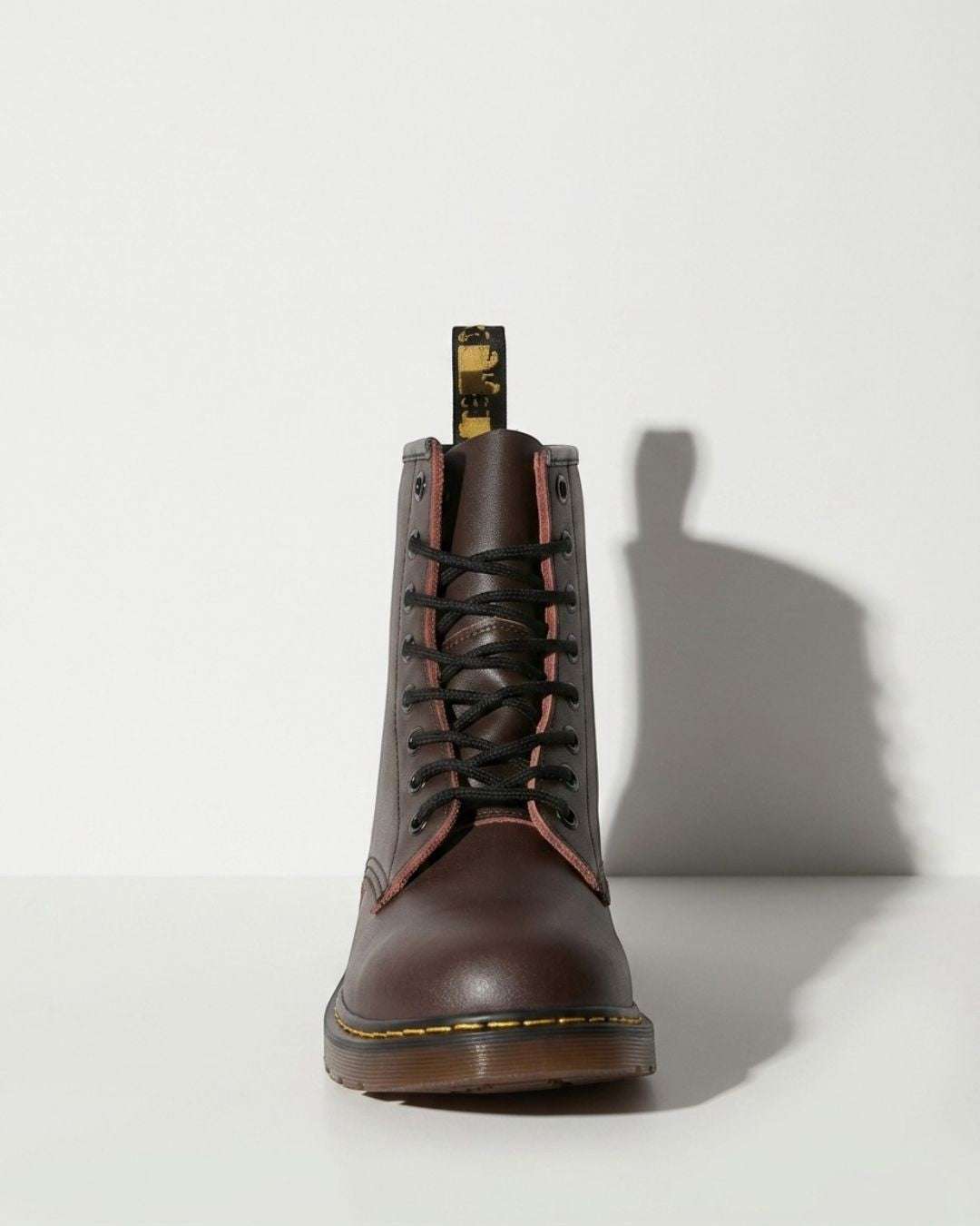 Edgy black women's lace-up combat ankle boots with a chunky sole, perfect for biker style and winter fashion.