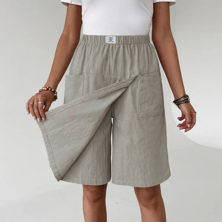 Women's black elastic waist active shorts with pockets, ideal for workouts, running, or casual summer wear.