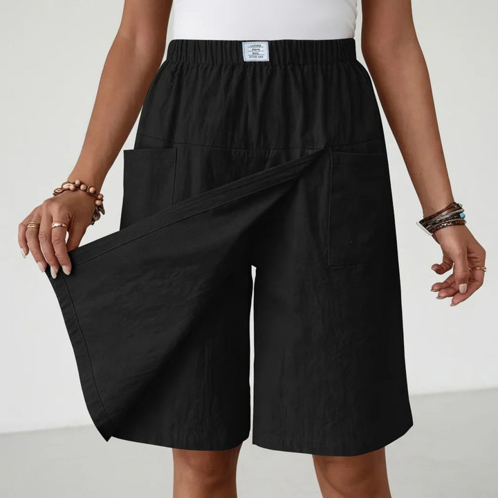 Comfortable women's athletic shorts with elastic waist & side pockets, perfect for workouts, hiking, or lounging.