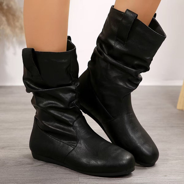 Comfortable brown slip-on flat ankle boots for women, ideal for everyday wear & casual versatility.