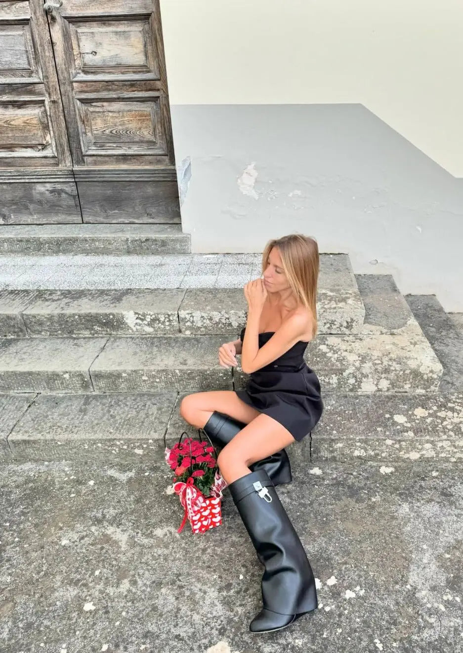 High fashion women's black glossy knee-high boots, sculptural wedge, perfect statement footwear.