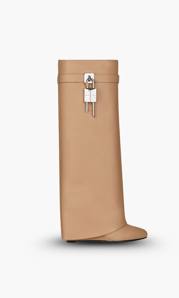 Versatile women's black glossy wedge knee-high boots, merging sculptural design with everyday wear.