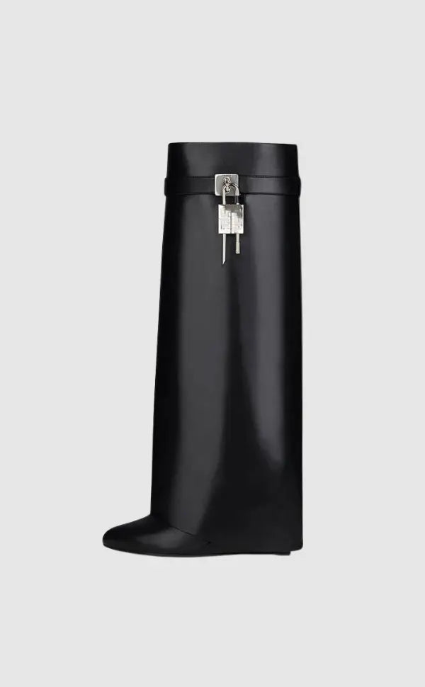 Elegant women's black wedge knee-high boots, featuring a glossy finish & futuristic sculptural heel.