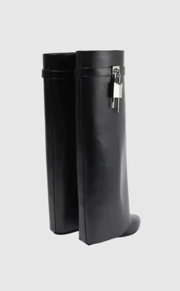 Futuristic black glossy knee-high boots for women, with an eye-catching sculptural wedge heel.