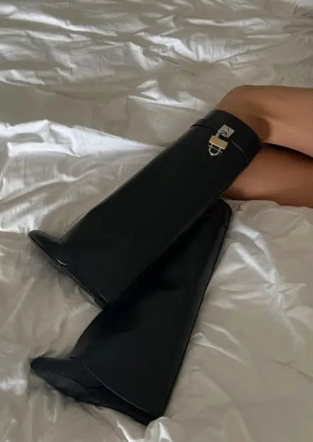 Street style ready women's black glossy sculptural wedge boots, knee-high & modern.