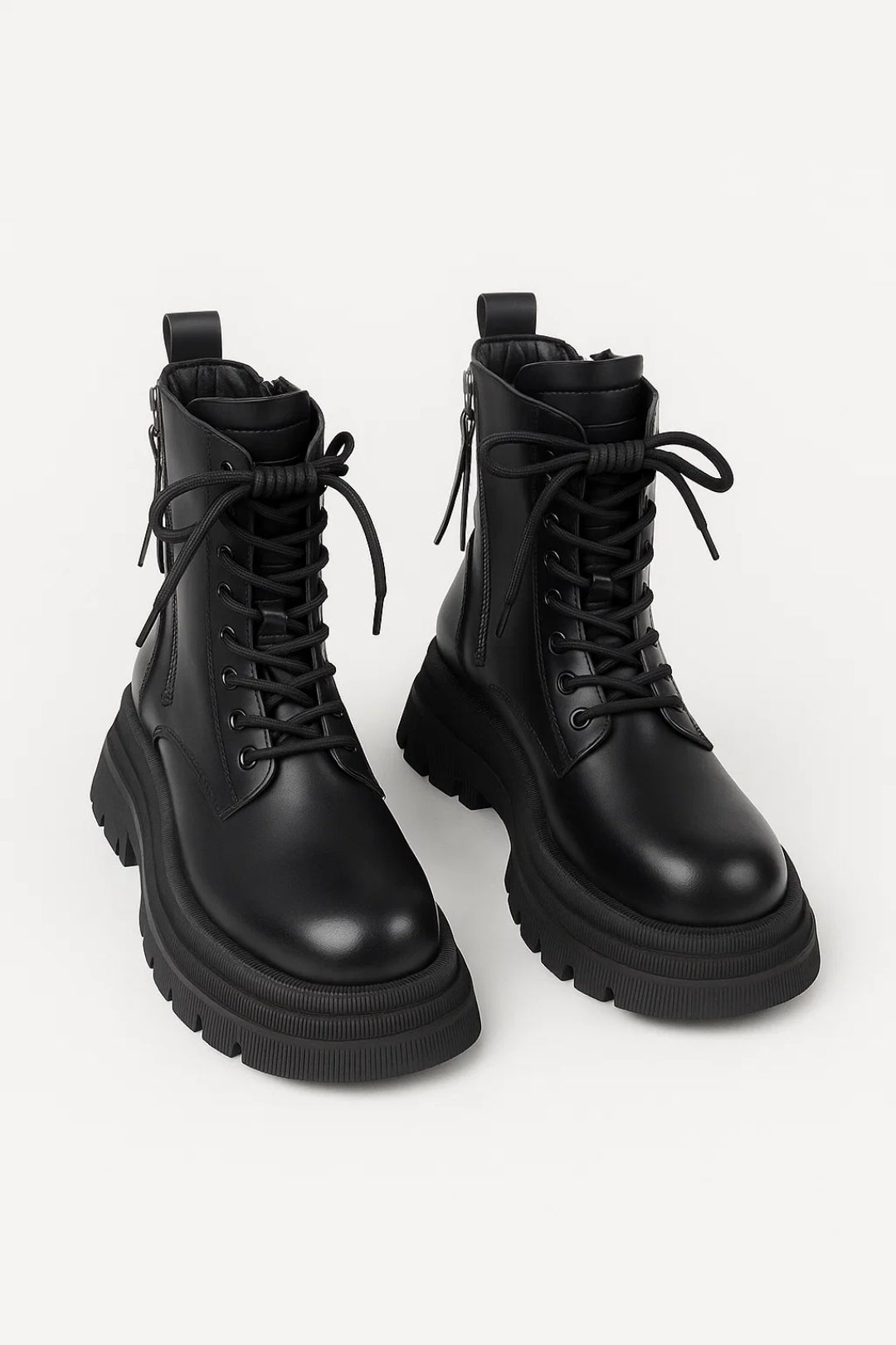 Women's black lace-up ankle boots with chunky platform sole, modern design for edgy fall fashion.