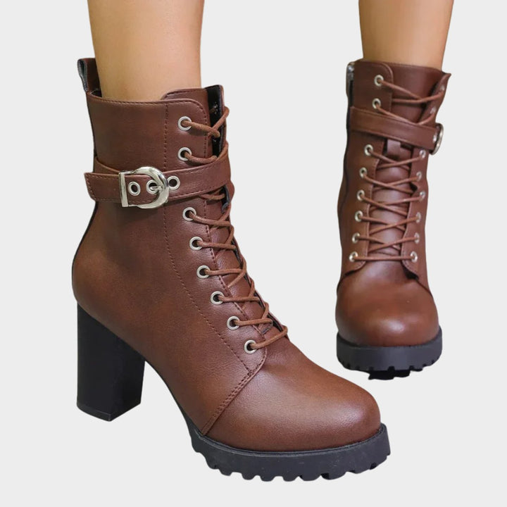 Women's black lace-up combat ankle boots with sturdy block heel & stylish buckle straps.