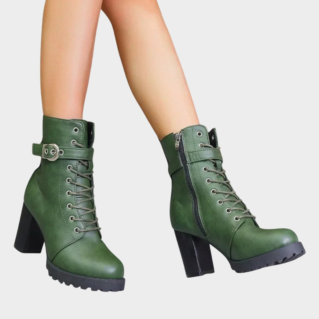Modern women's lace-up combat ankle boots. Black finish, comfortable block heel & trendy buckle adornments.