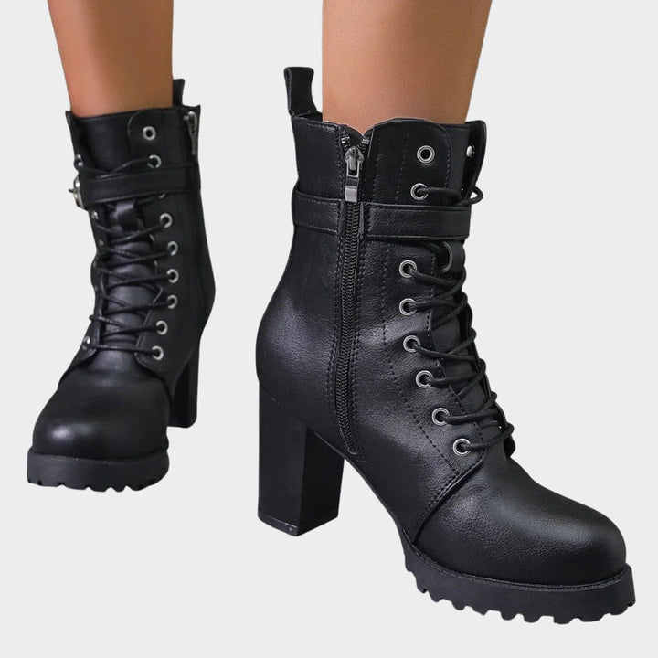 Versatile women's black ankle boots. Features lace-up front, durable block heel & buckled strap.