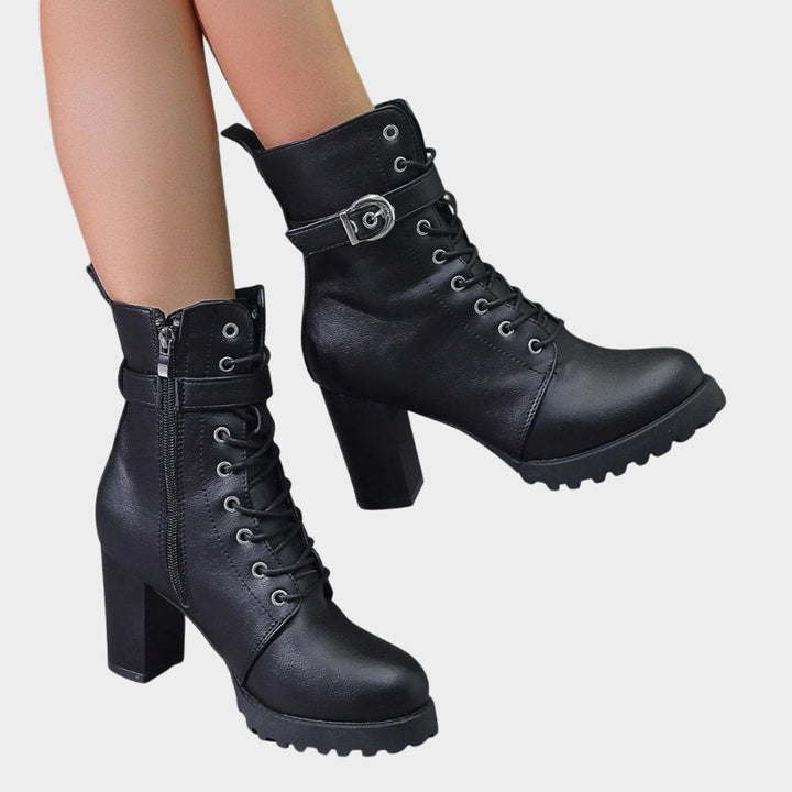 Fashion-forward women's combat boots with secure lace-up closure, block heel, and chic buckle strap.