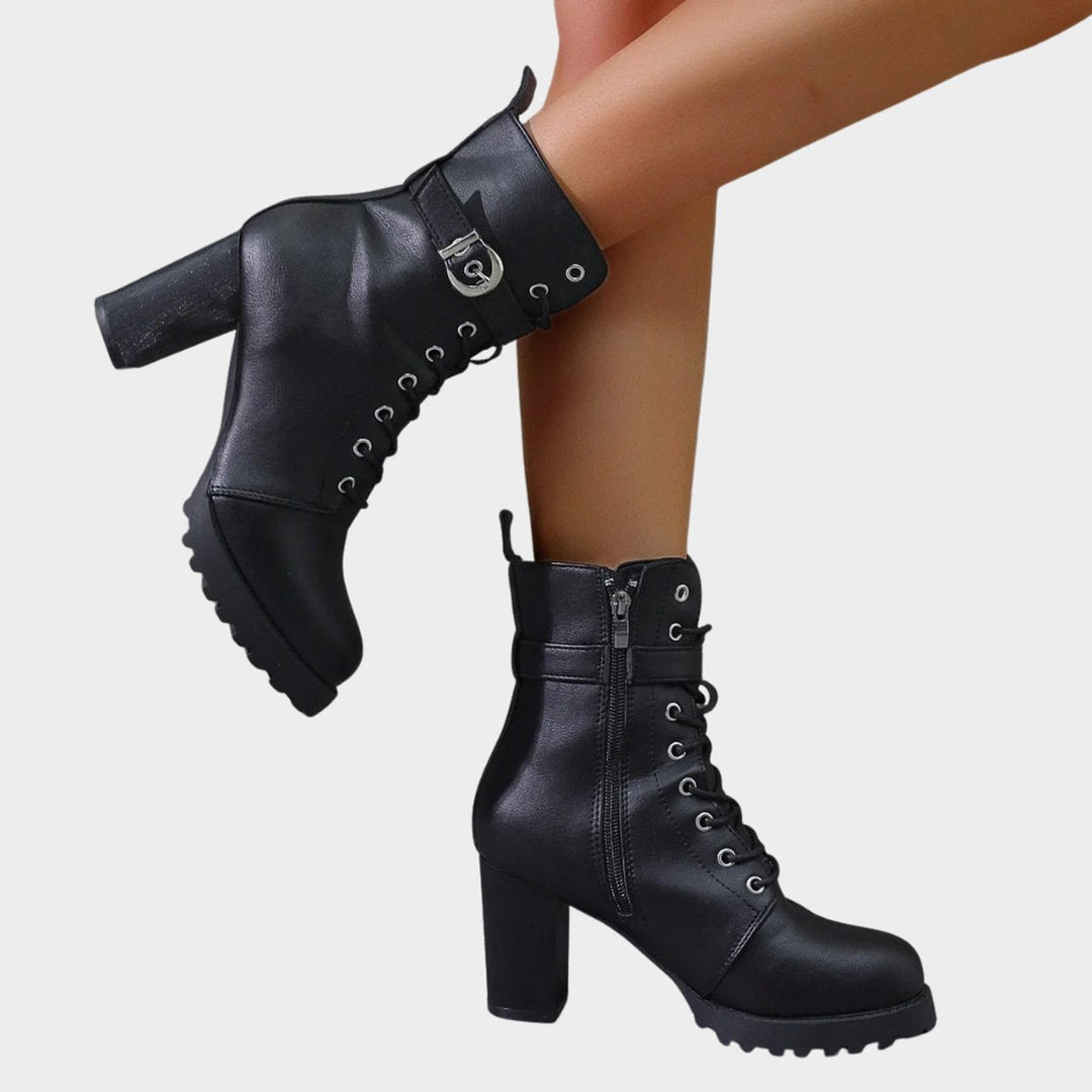 Black women's combat ankle boots with military-inspired lace-up design, block heel & buckle accents.
