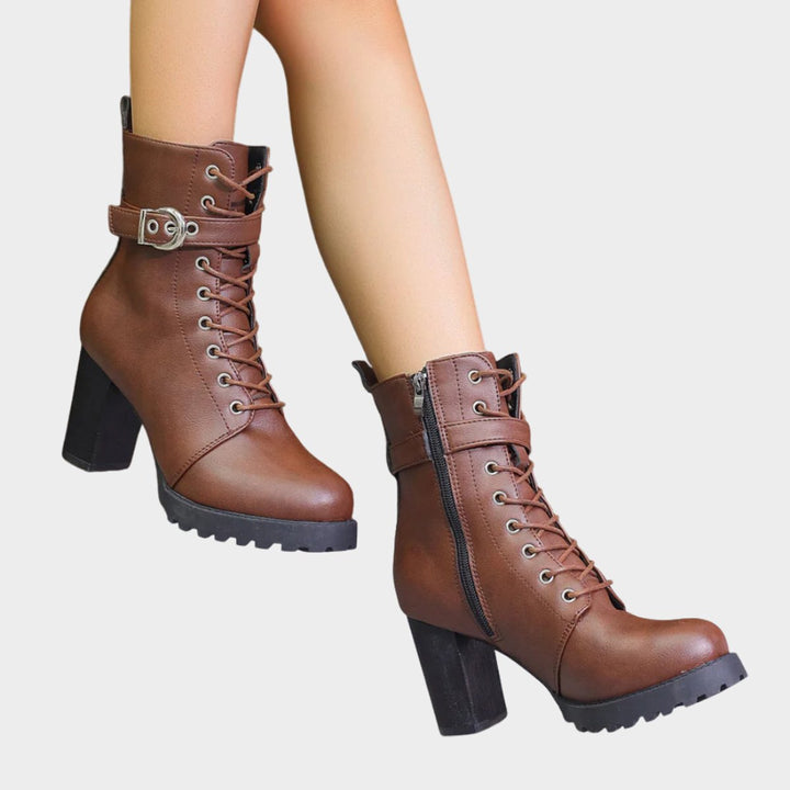 Elegant women's black lace-up combat boots. Stylish block heel and sleek buckle details make a statement.